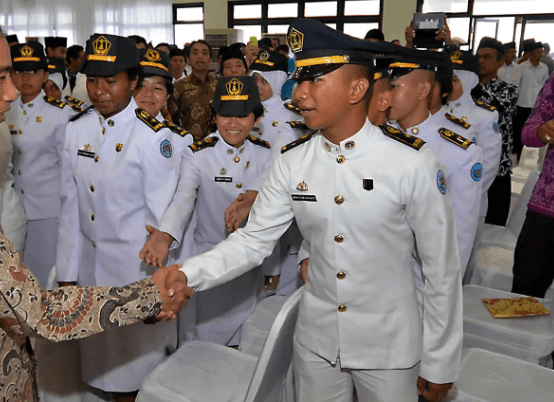 Lulusan IPDN di depan peta Indonesia, simbol penempatan nasional